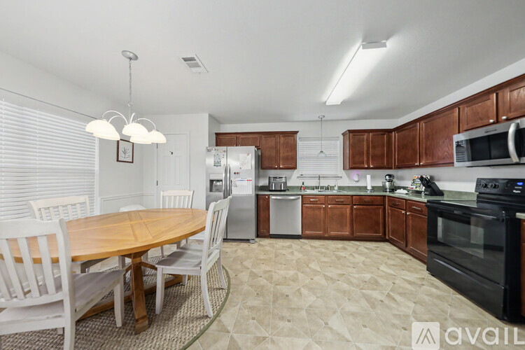 A kitchen with a table and chairs in the middle of the room.