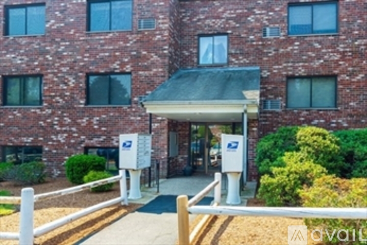 A brick building with a covered walkway entrance.