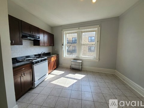 A kitchen with white appliances and brown cabinets.
