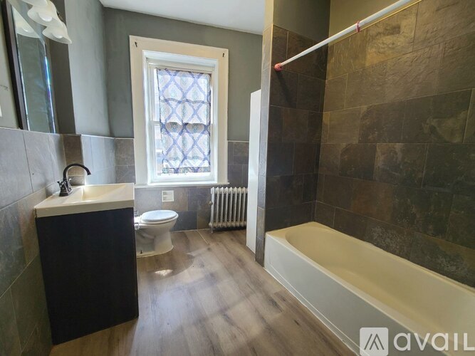 A bathroom with a toilet, sink, and bathtub.