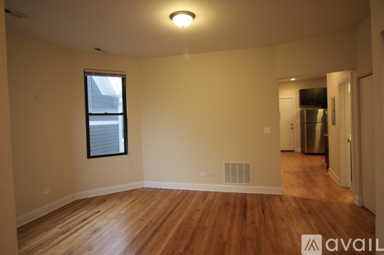 A room with wooden floors and a window.