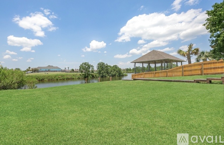 A gazebo sits in the middle of a grassy field.