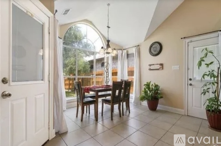 A dining room with a table set for four.