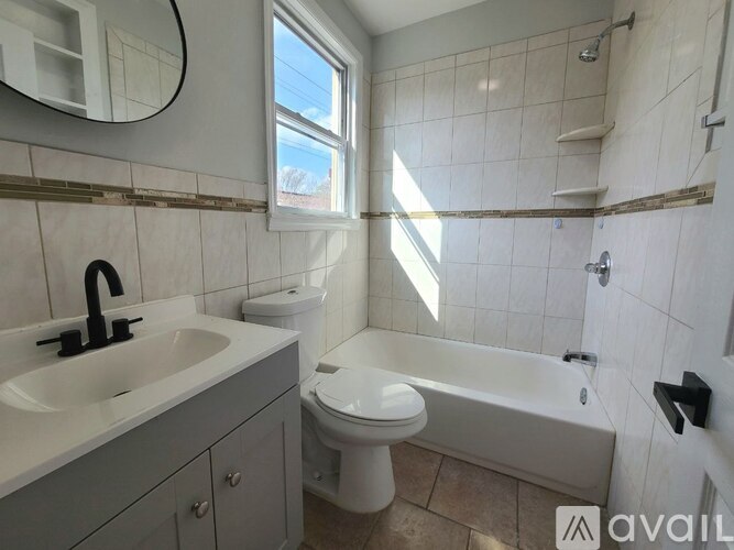 A bathroom with a white toilet, sink, and bathtub.