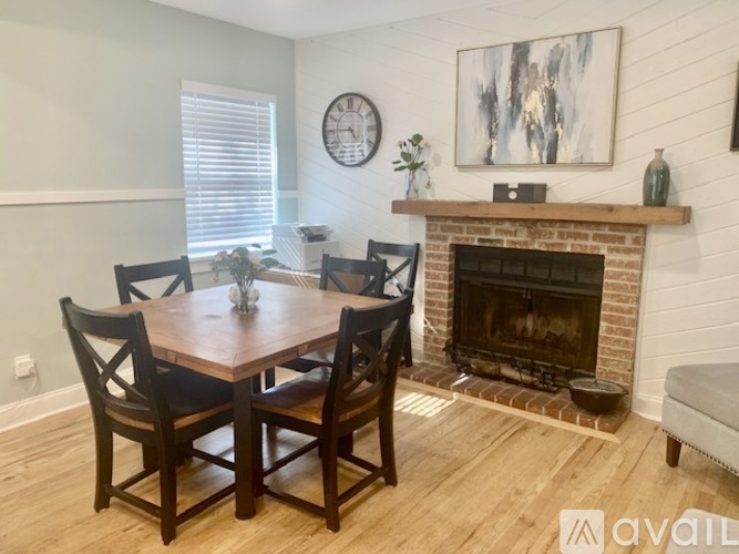 A dining room with a wooden table and chairs.