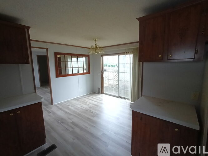 A room with wooden cabinets and a chandelier.