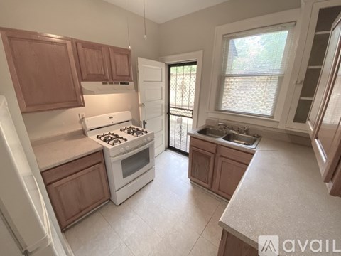 A kitchen with a white stove top oven and white fridge.