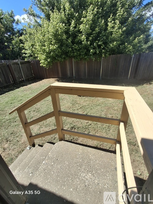 A wooden deck with a bench in the middle of it.