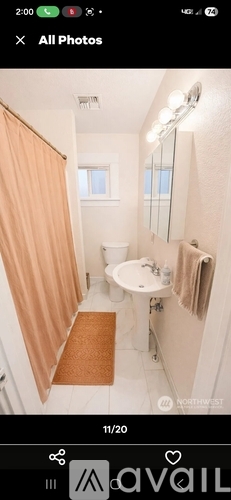 A bathroom with a toilet, sink, and mirror.