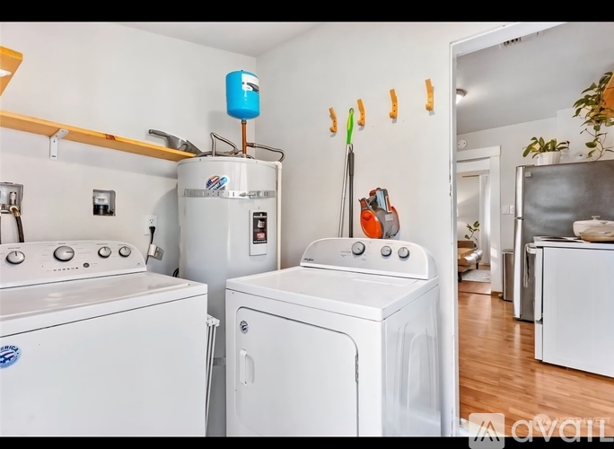 A white washing machine and dryer in a laundry room.