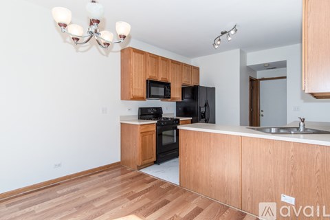 A kitchen with wooden cabinets and a white countertop.