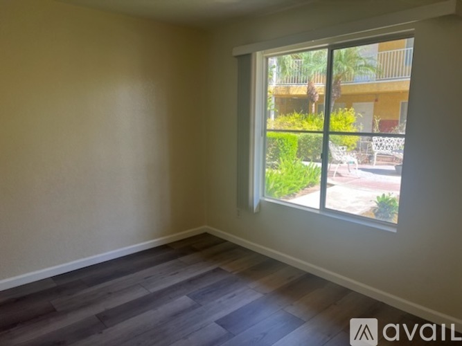 A room with a large window overlooking a patio.