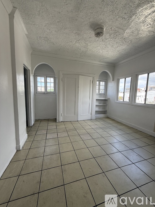 A room with white walls and a tiled floor.