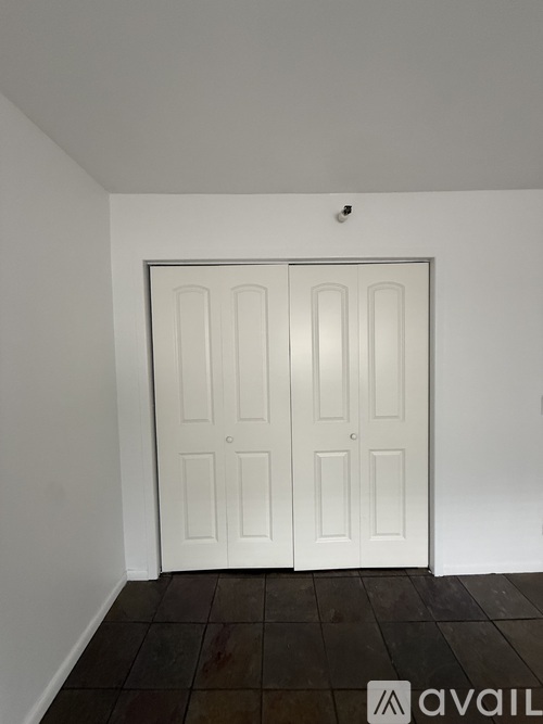 A white door in a room with a tiled floor.