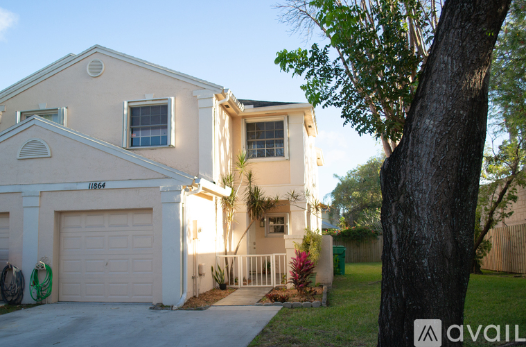 A two-story house with a garage and a driveway.
