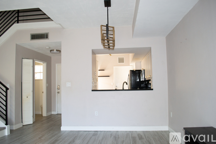 A modern kitchen with a stove top oven and a window.