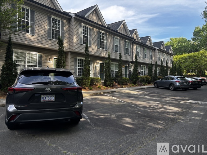 A black SUV is parked in a parking lot in front of a building.