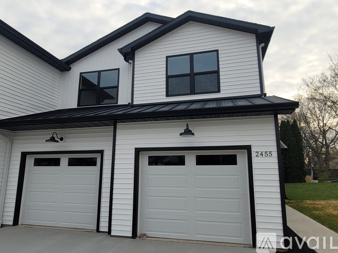 A two-car garage with a white exterior and black trim.