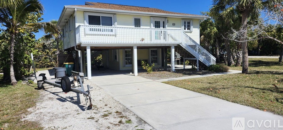 A house with a porch and a lawn in front.