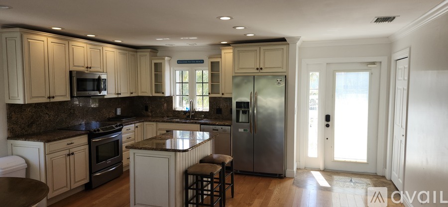 A kitchen with granite countertops and stainless steel appliances.
