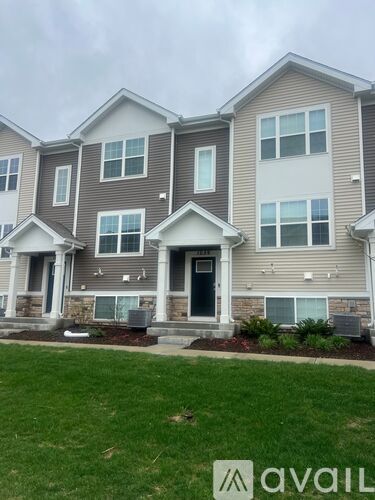 A row of houses with the front door of the first one visible.