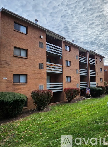 A brick building with the word "avail" on the grass in front.