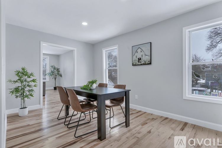 A dining room with a table and chairs.