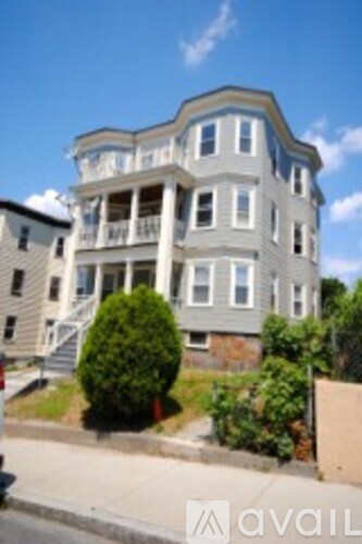 A large two story house with a balcony on the second floor.
