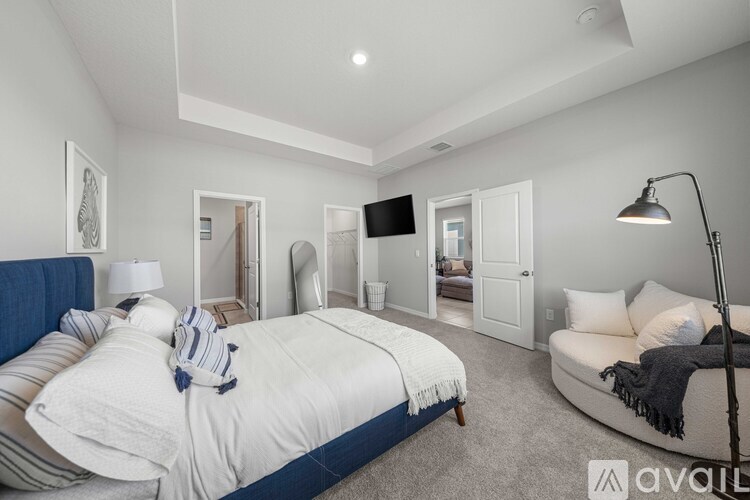 A bedroom with a large bed and a couch.