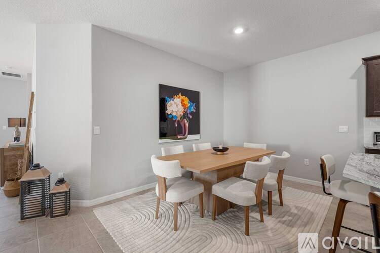 A dining room with a wooden table and chairs.