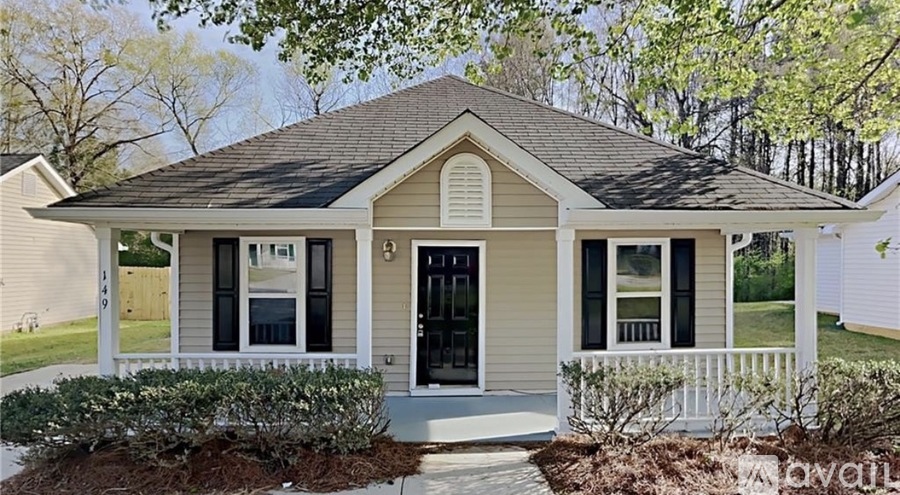 A house with a front porch and a black door.