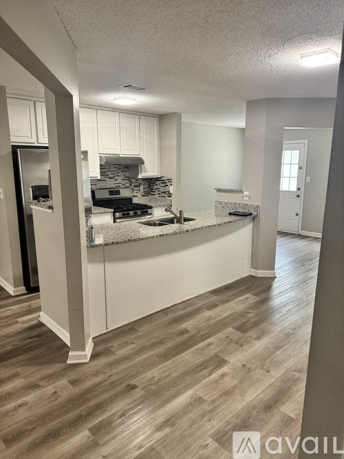 A kitchen with a stove top oven and a counter top.