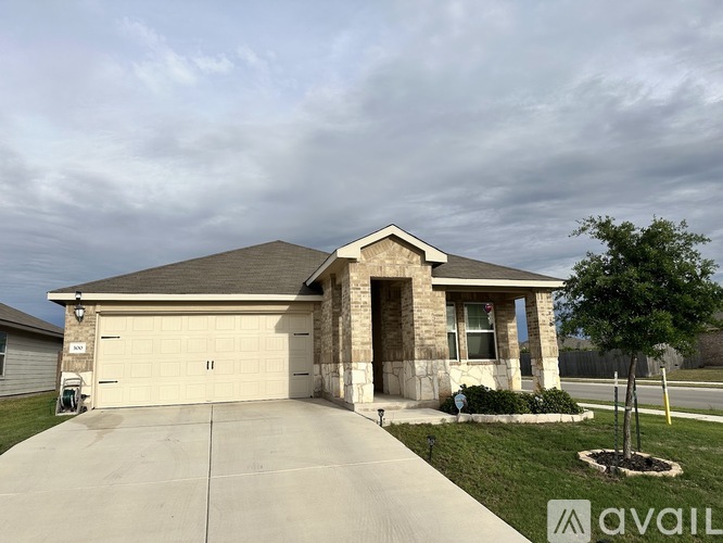 A house with a garage and a driveway in front.