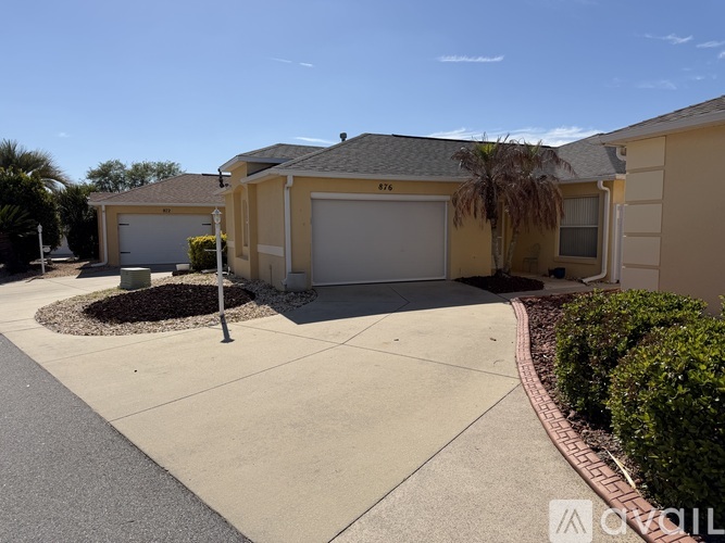 A house with a driveway and garage doors.