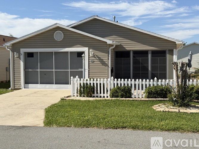 A house with a white picket fence in front.