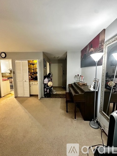 A woman is standing in a room with a piano.
