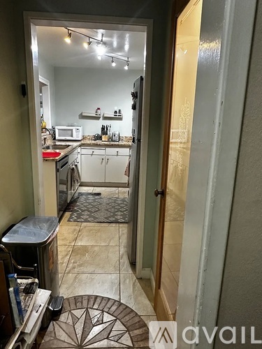 A kitchen with a microwave on the counter.