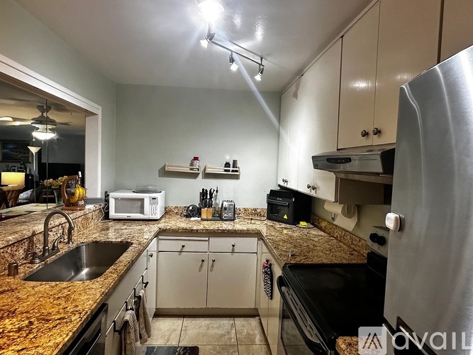 A kitchen with granite countertops and stainless steel appliances.