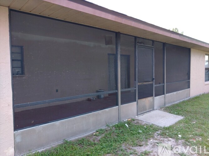 A building with a pink wall and a row of windows.