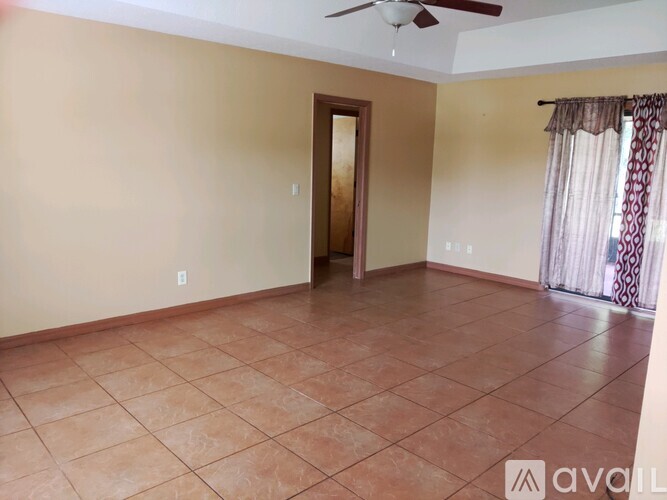A room with a tiled floor and a ceiling fan.