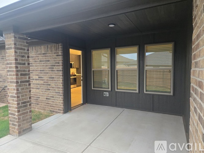 A house entrance with a glass door and a brick wall.