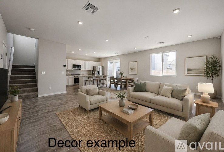 A living room with a couch, coffee table, and a staircase.