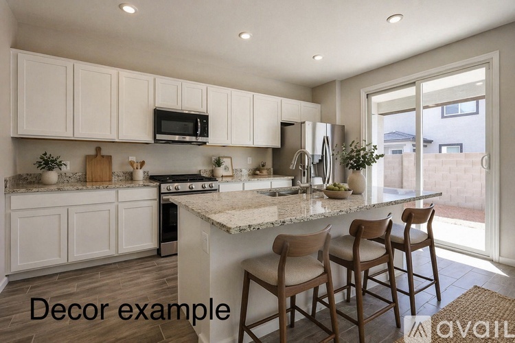 A kitchen with white cabinets and a granite countertop.
