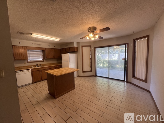 A kitchen with a wooden island in the middle of the room.
