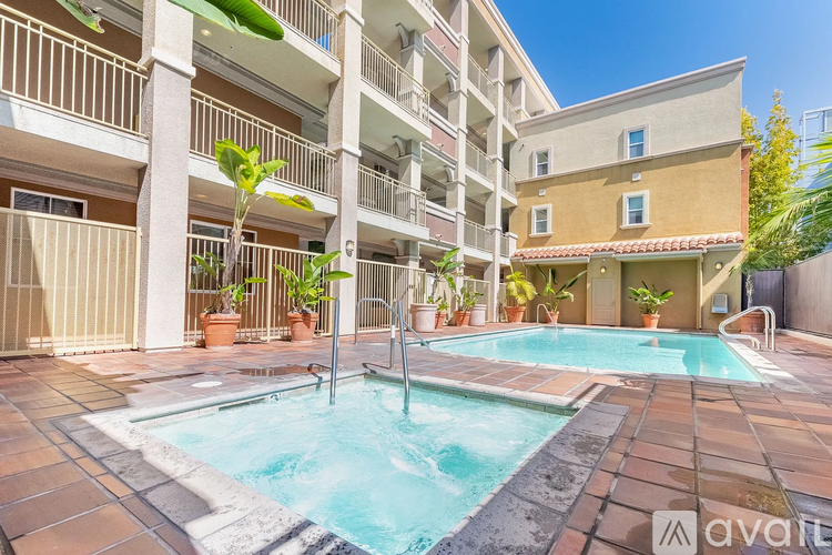 A pool in a courtyard surrounded by apartment buildings.