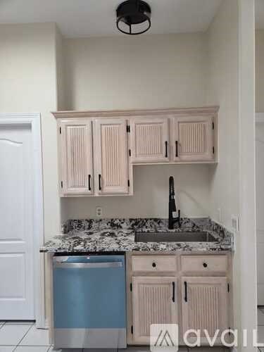 A kitchen with a sink and cabinets.