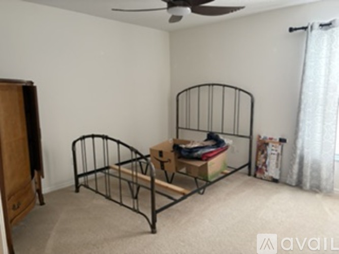 A room with a bed and a dresser.