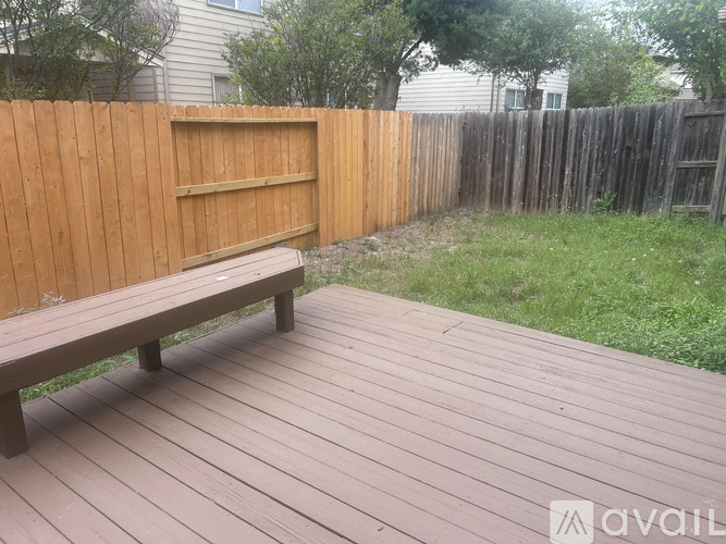 A wooden bench sits on a wooden deck.