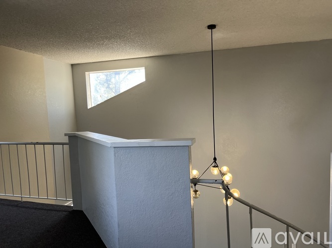 A room with a white wall and a window.