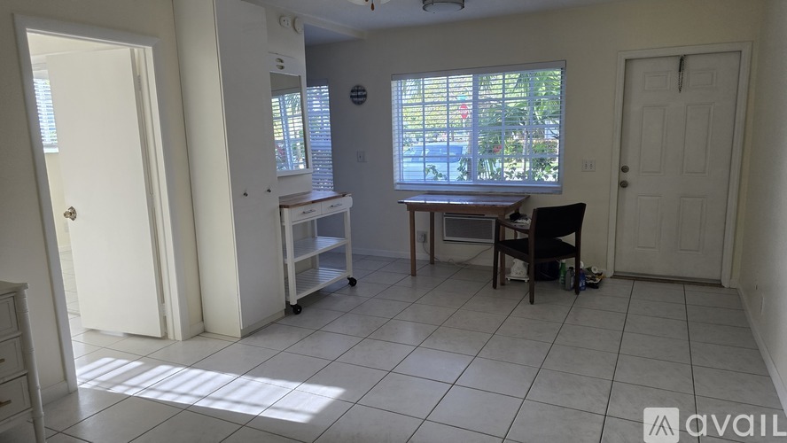 A room with a table and chairs in it.